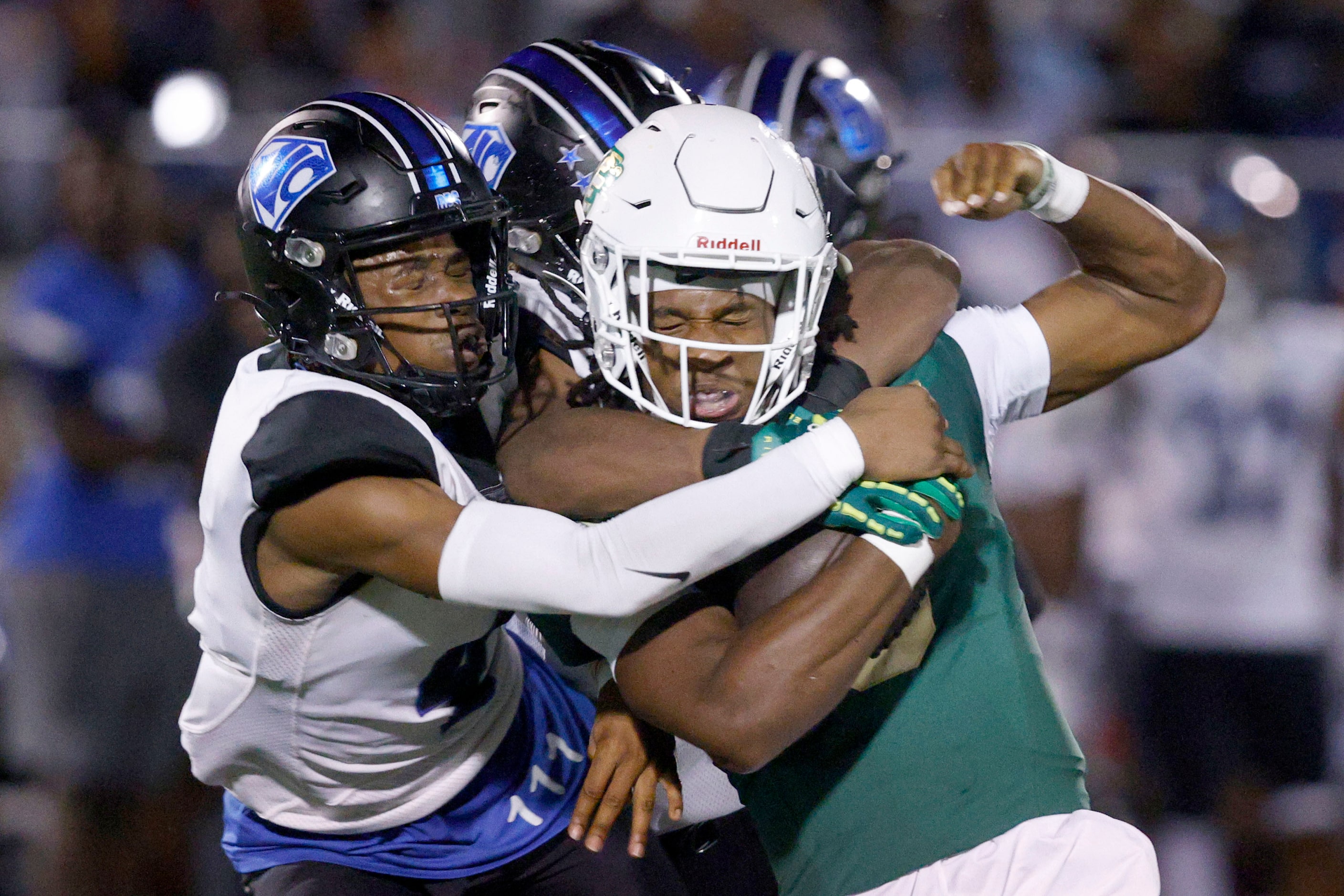 DeSoto's Kelden Ryan (3) is tackled by North Crowley's Draden Fullbright (4), left, and...