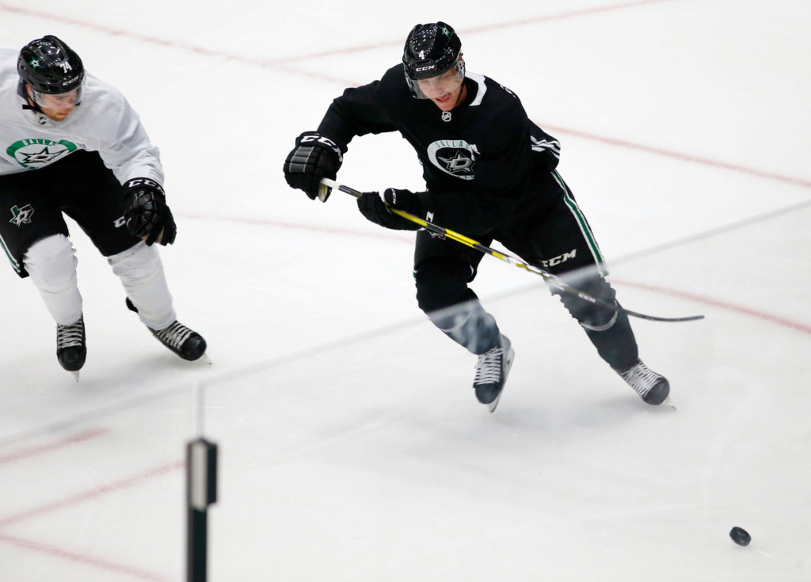 Dallas Stars defenseman Miro Heiskanen (4) and Dallas Stars Anthony Nellis (74) go after the...