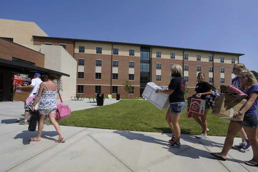 Freshman students and their families haul belongings into the new, $26.7 million Lumberjack...