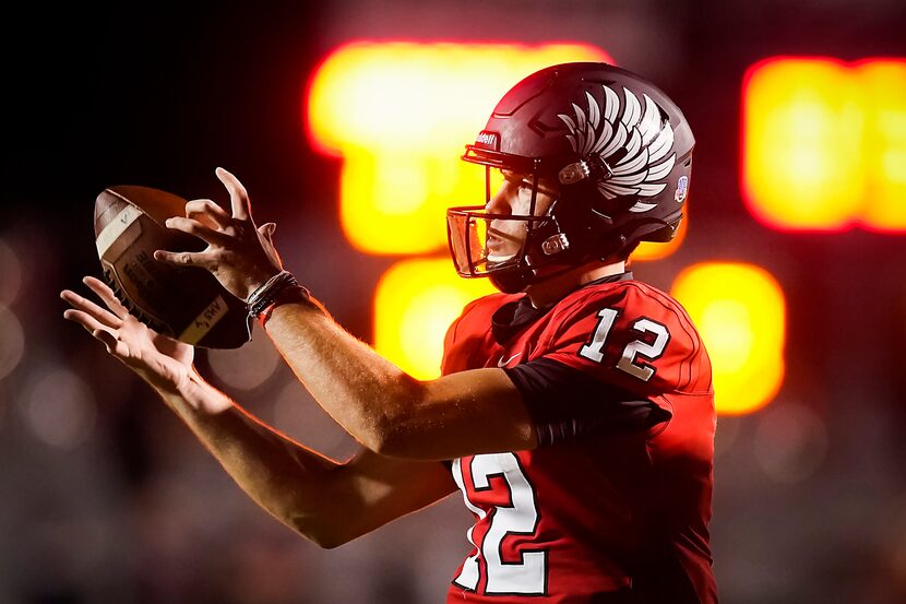 Argyle quarterback CJ Rogers grabs a snap during the first half of a high school football...