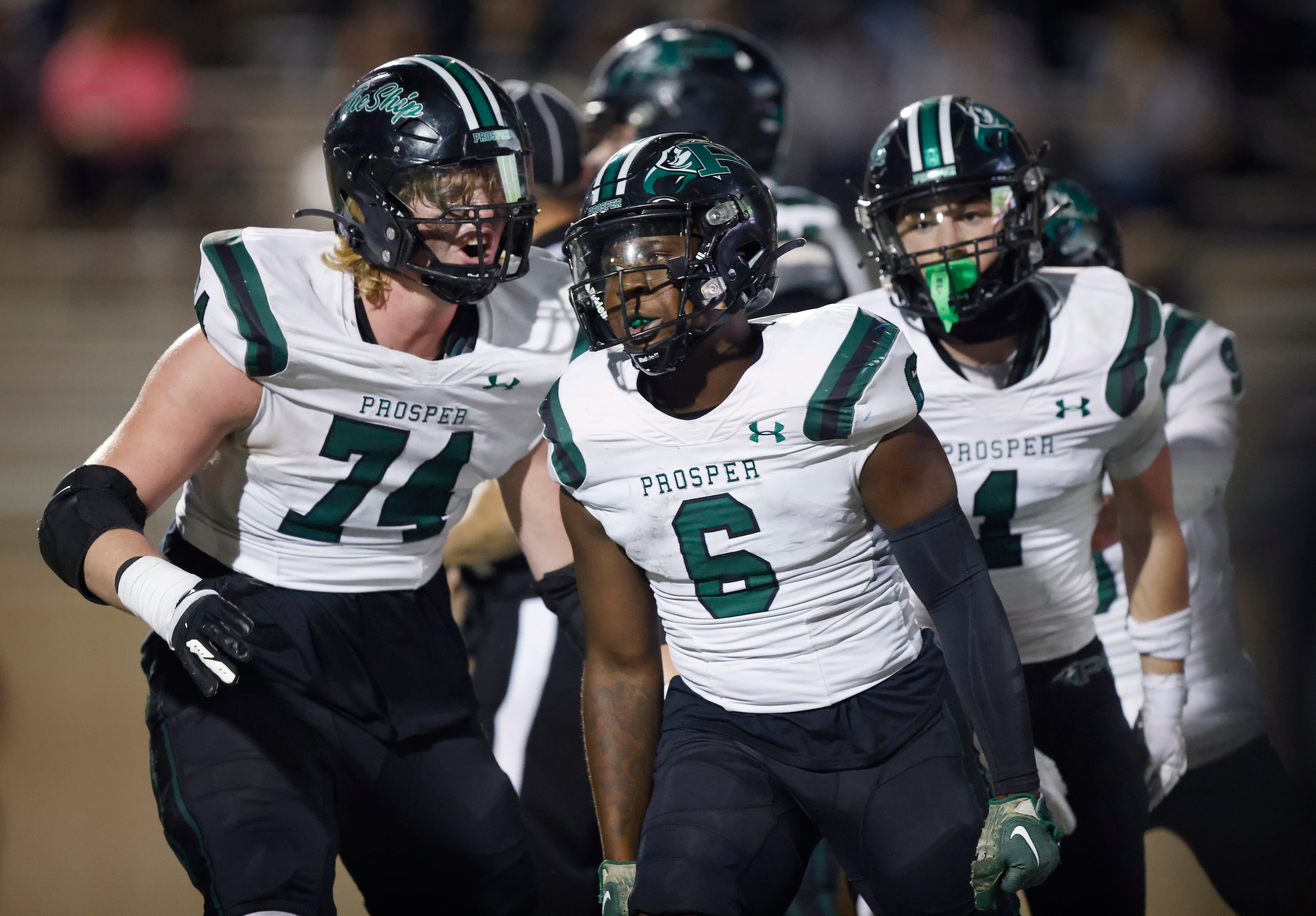 Prosper High running back Bryce Robinson (6) is congratulated on his first half touchdown by...