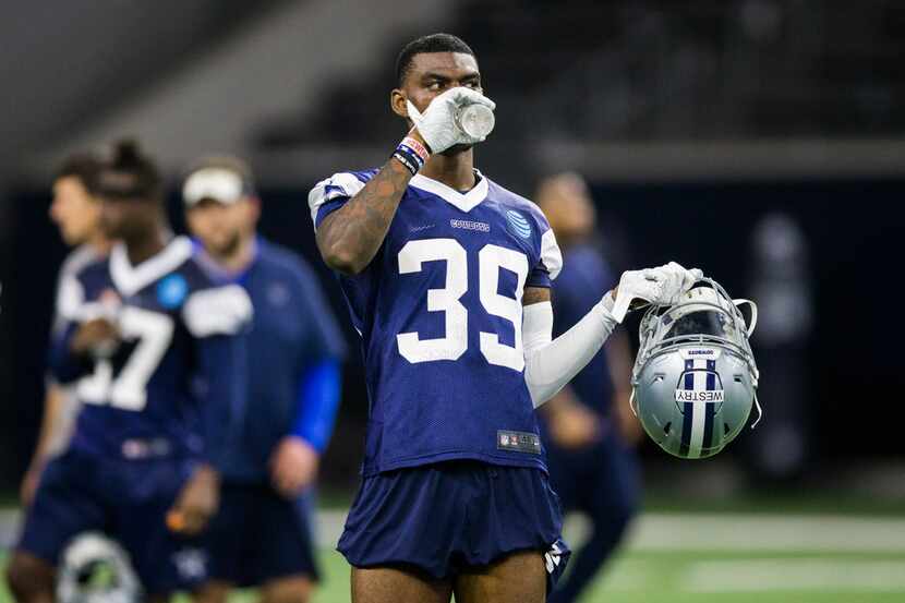 FILE - Cowboys cornerback Chris Westry (39) drinks some water during OTAs on Wednesday, May...