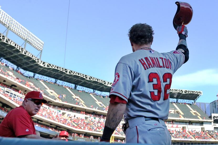 Former Rangers outfielder Josh Hamilton tips his hat to the fans as they boo him as he...