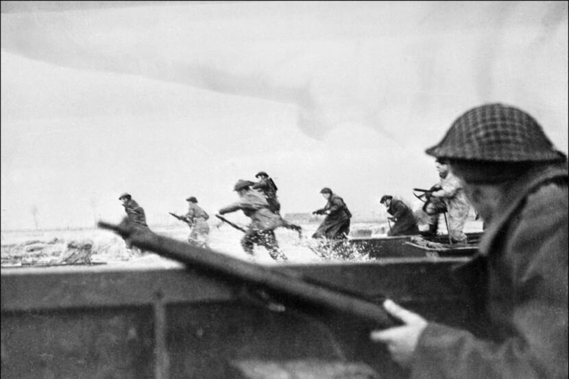 Canadian soldiers ran ashore as they landed on Juno Beach in Normandy, France, as part of...