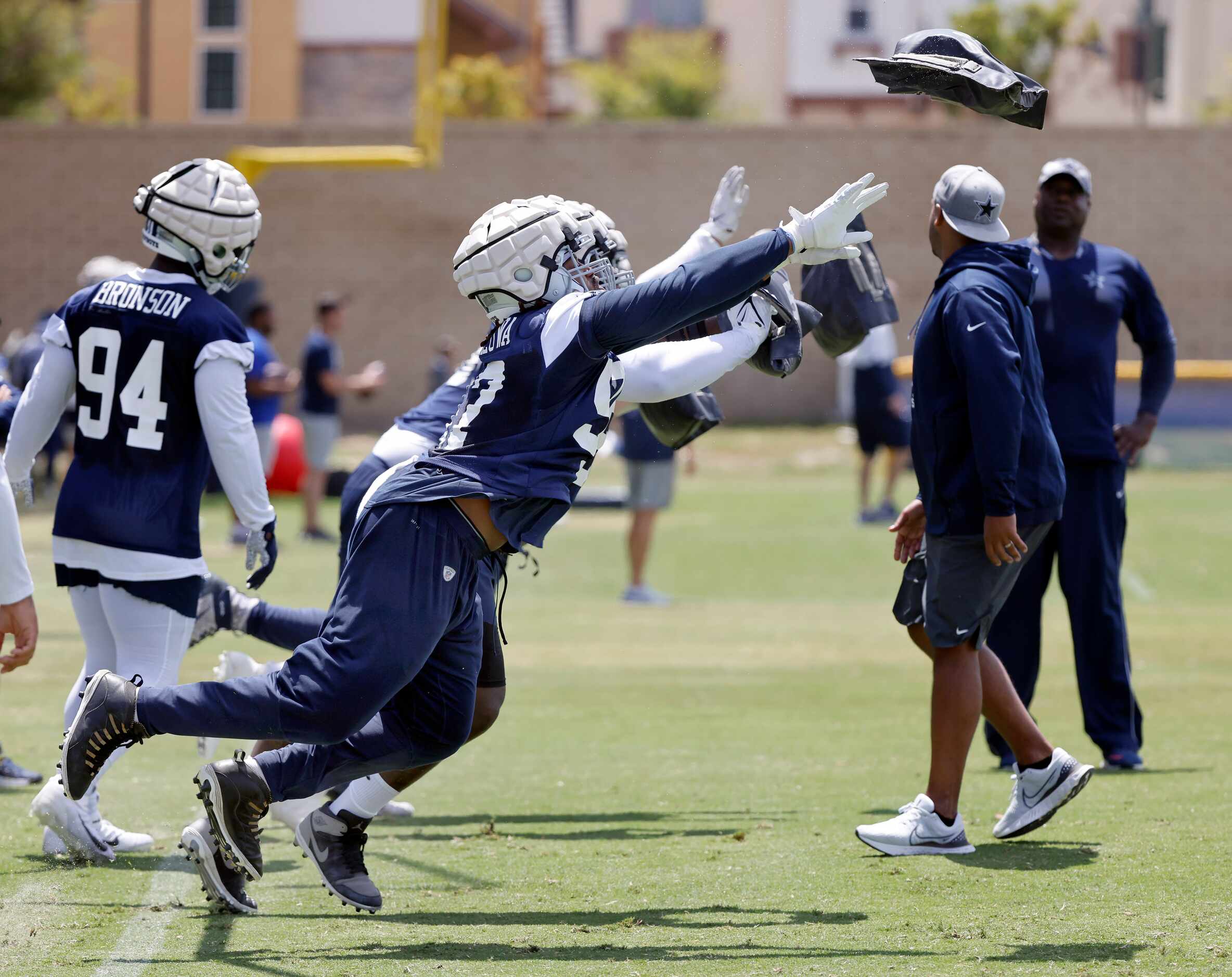 Dallas Cowboys defensive lineman toss heavy beanbag weights as they explode off the line...