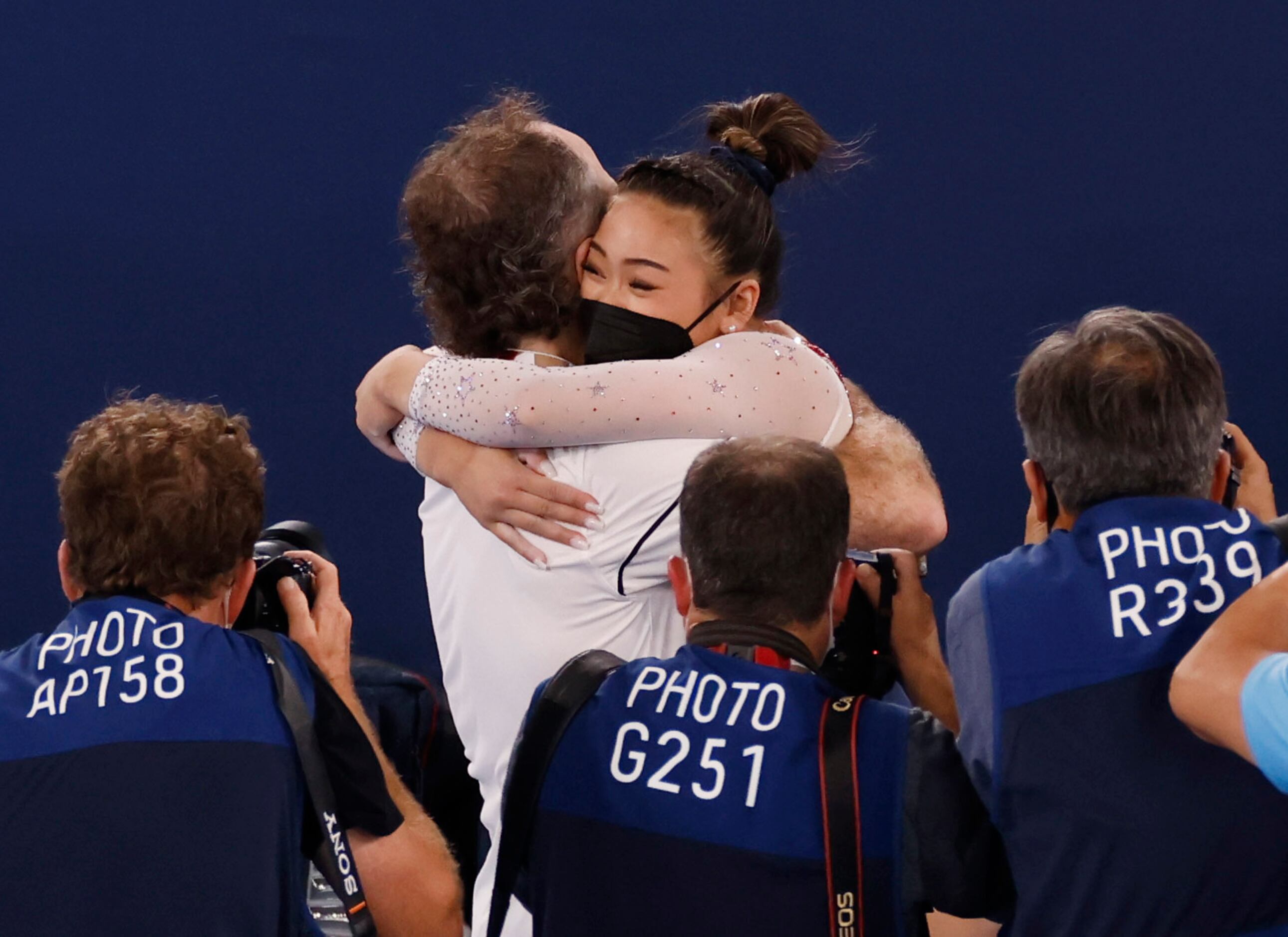 USA’s Sunisa Lee hugs her coach Jeff Graba after winning gold in the women’s all-around...