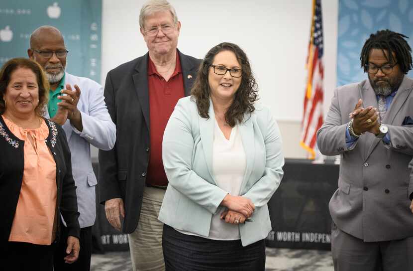 Angélica Ramsey, surrounded by Fort Worth ISD Board of Trustee members from left, Camille...