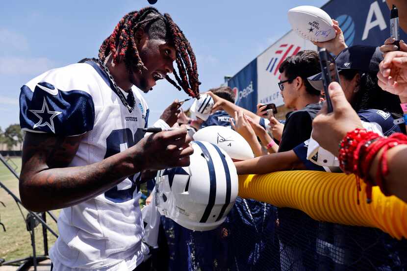 Dallas Cowboys wide receiver CeeDee Lamb (88) signs autographs for fans following the first...