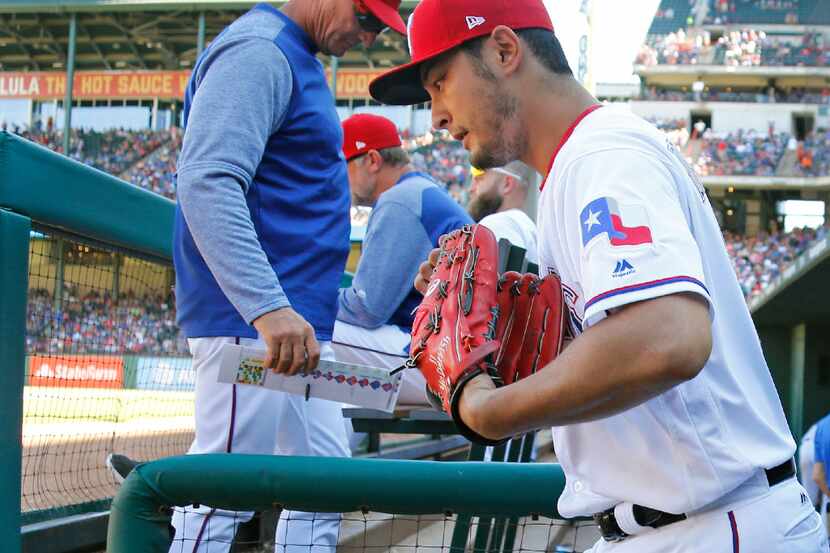 Texas Rangers starting pitcher Yu Darvish (11) heads out of the dugout past Texas Rangers...