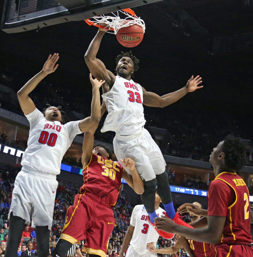 SMU forward Semi Ojeleye (33) dunks over USC guard Elijah Stewart (30) in the second half...