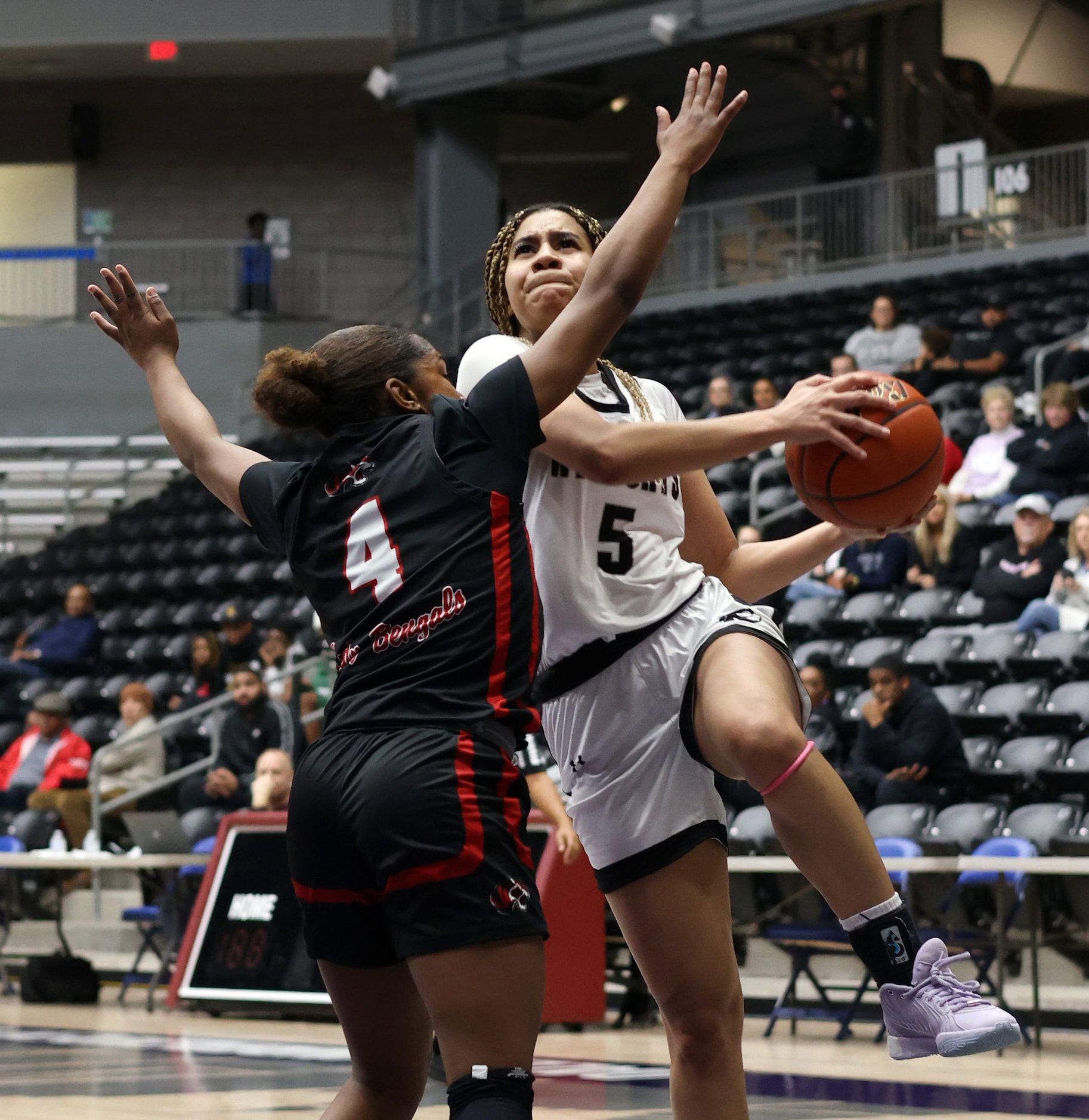 Denton Guyer guard Amhya Langford (5), right, drives to the basket as she is defended by...