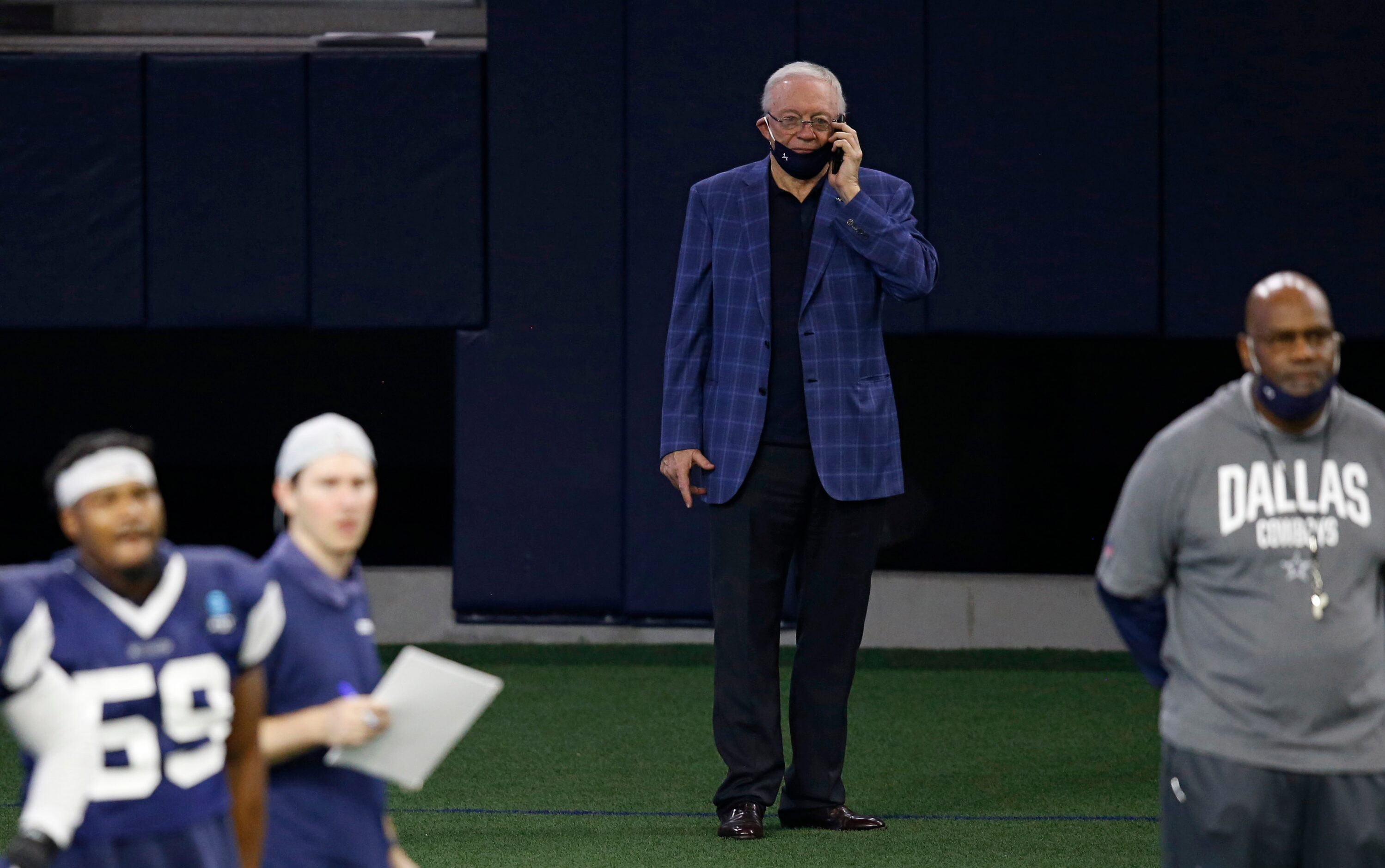 Dallas Cowboys owner and general manager Jerry Jones conducts a radio interview on the phone...