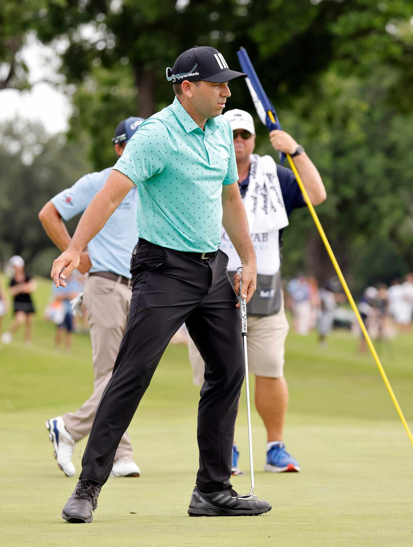 Professional golfer Sergio Garcia reacts after missing his birdie putt on No. 18 during...