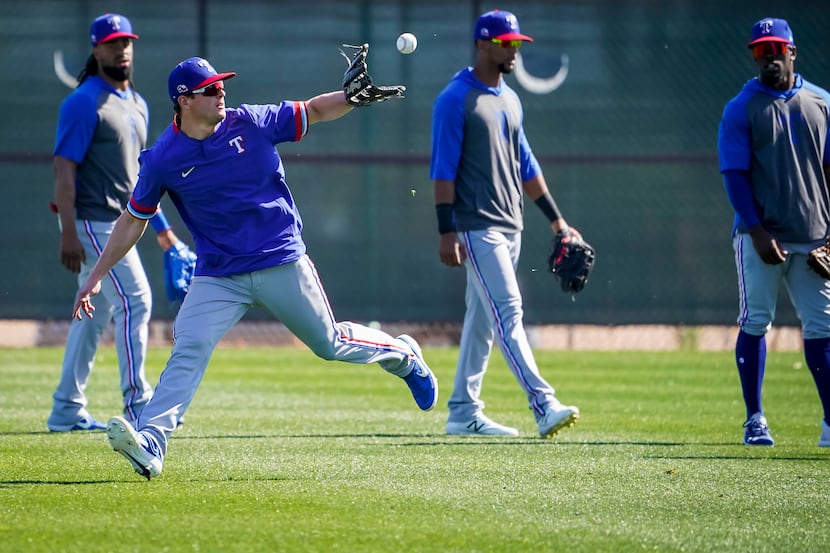 Texas Rangers infielder Nick Solak makes a catch while participating in a fielding drill...
