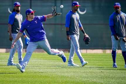 Texas Rangers infielder Nick Solak makes a catch while participating in a fielding drill...