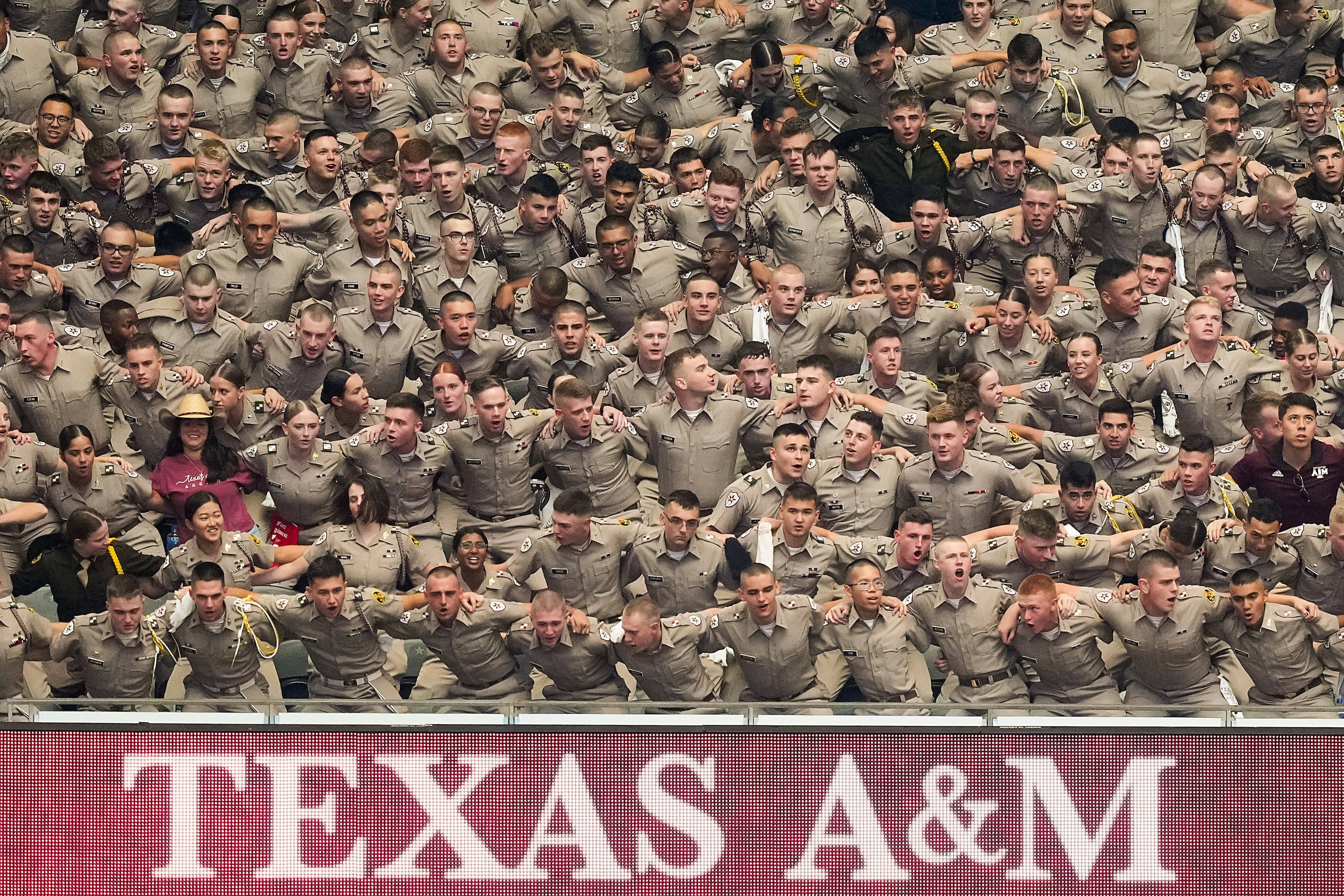 Members of the Texas A&M Corps of Cadets sing the Aggie War Hymn before an NCAA football...