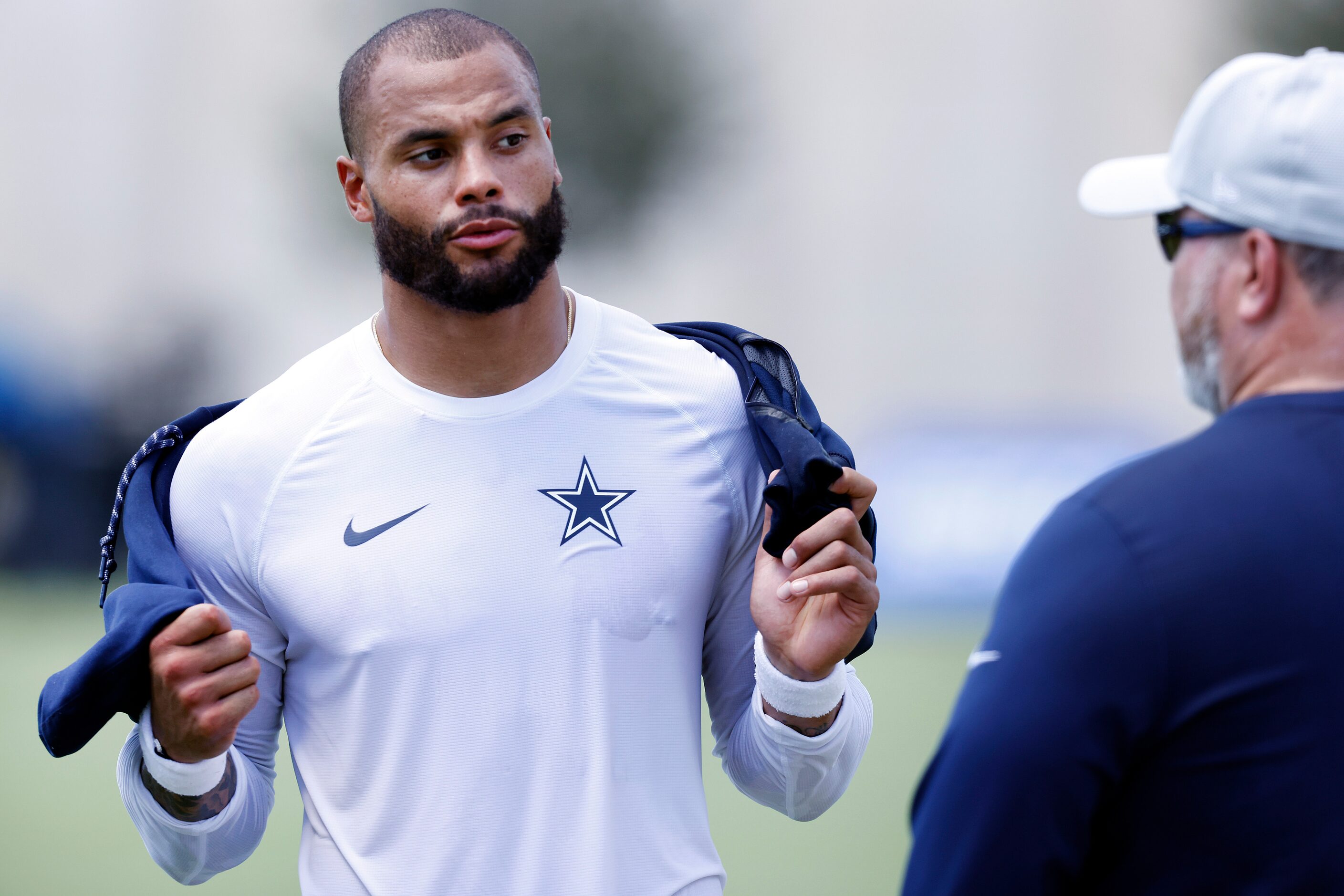 Dallas Cowboys quarterback Dak Prescott visits with head coach Mike McCarthy following...