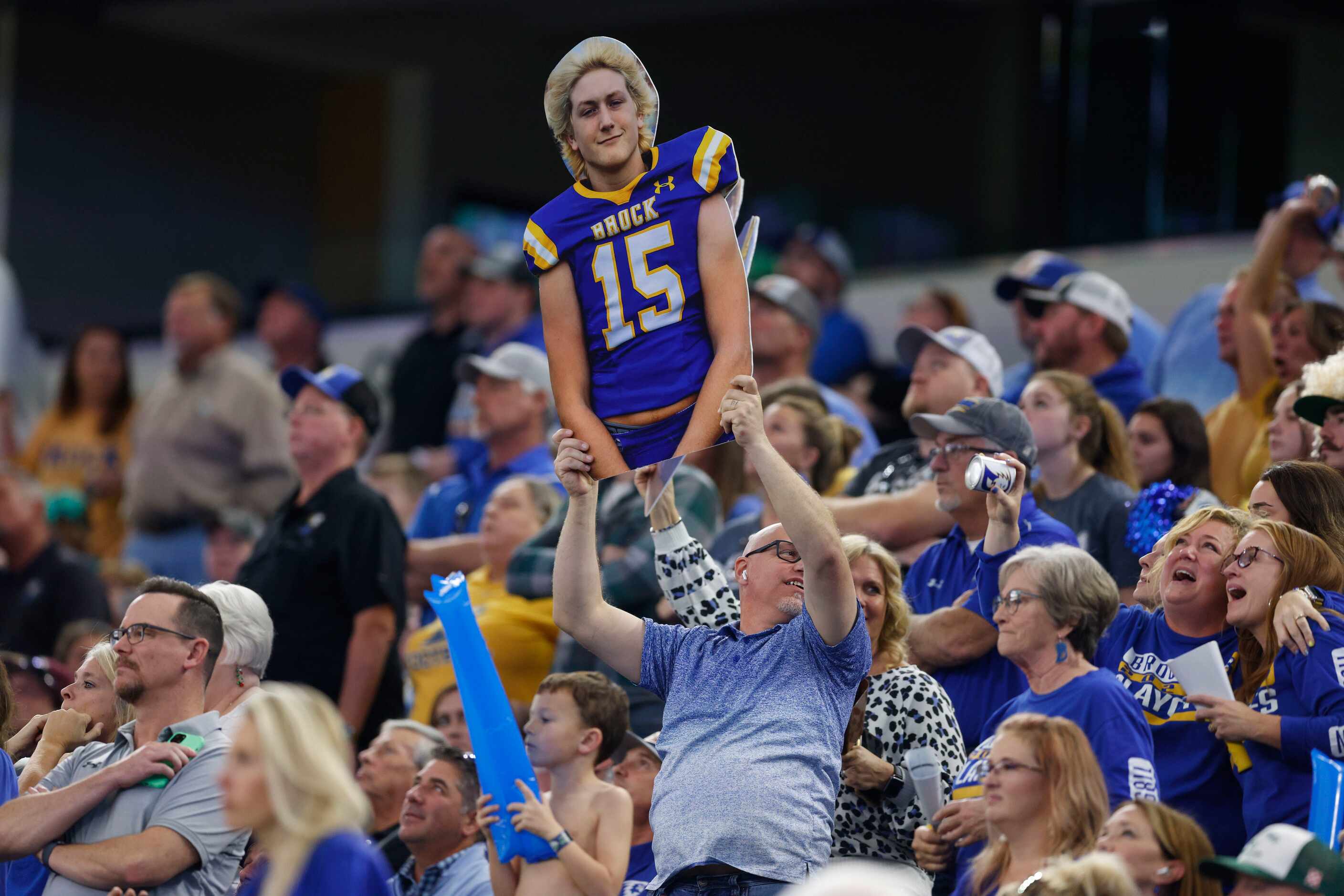 A Brock fan raises a cutout of Brock linebacker Cooper Massey (15) during the second quarter...