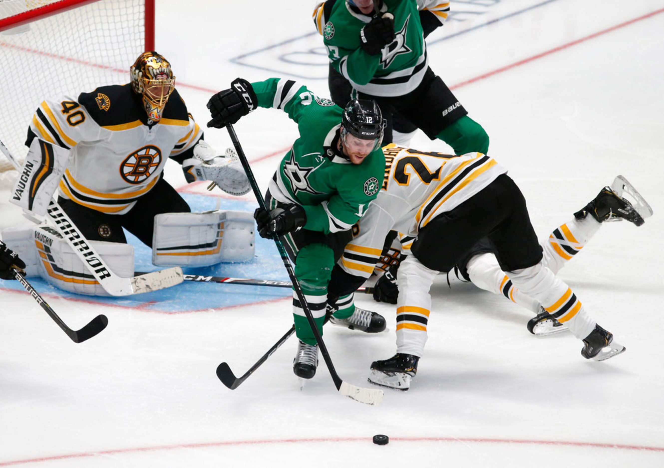 Dallas Stars center Radek Faksa (12) looks to advance the puck as Boston Bruins center Par...