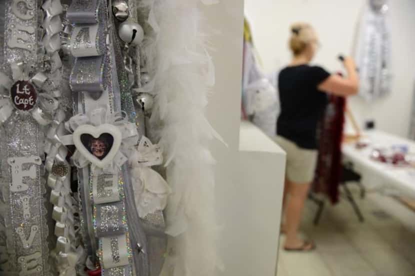 
A Plano Senior High School mum hangs at the Mum and Garter Shop in Plano on Sept. 11. The...