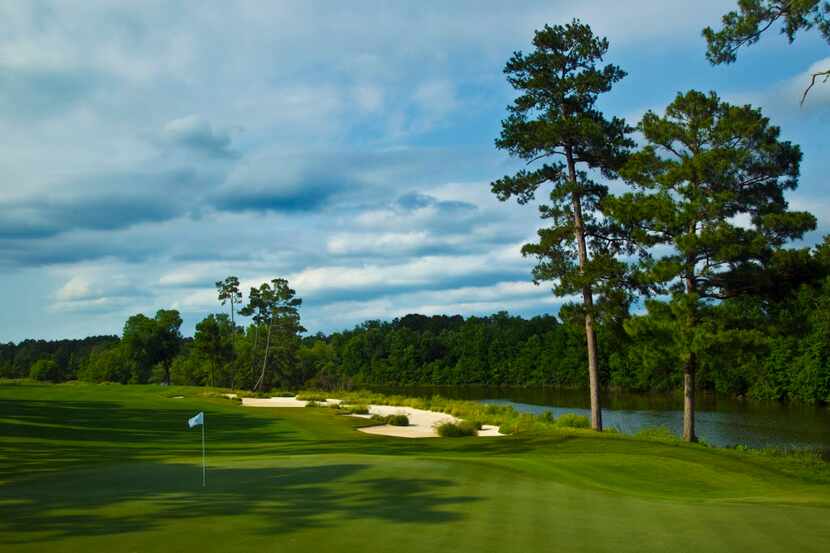 The pines on the right are part of the Whispering Pines Golf Club logo and are seen adjacent...