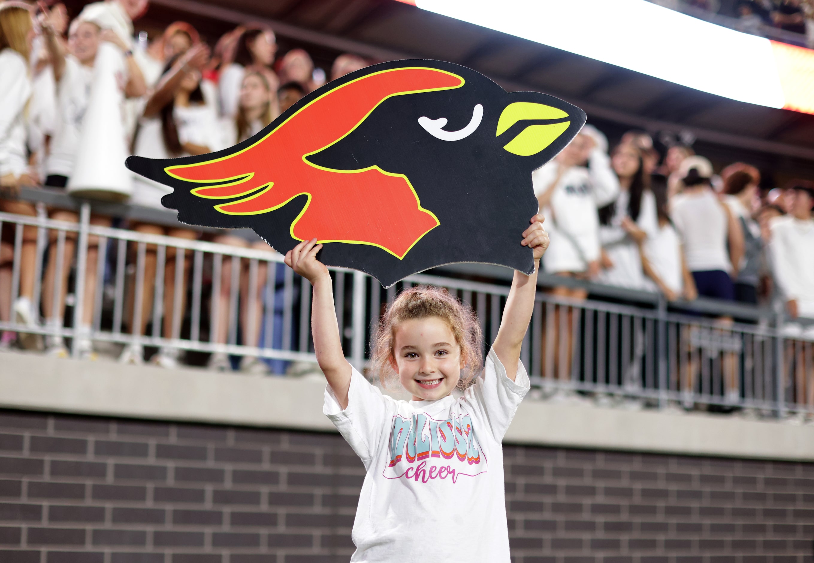 5-year-old Charlee Dykes cheers during the Prosper Walnut Grove High School at Melissa High...