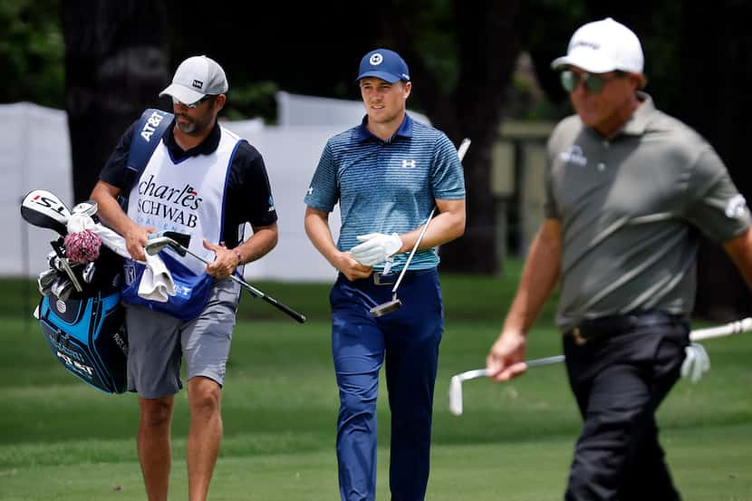 Professional golfer Jordan Spieth walks up the 9th fairway after sticking his approach shot...