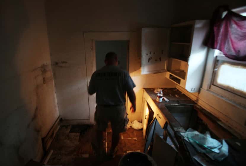 JP Bonnelly, head of Duck Team 6, searches for street dogs inside an abandoned home....