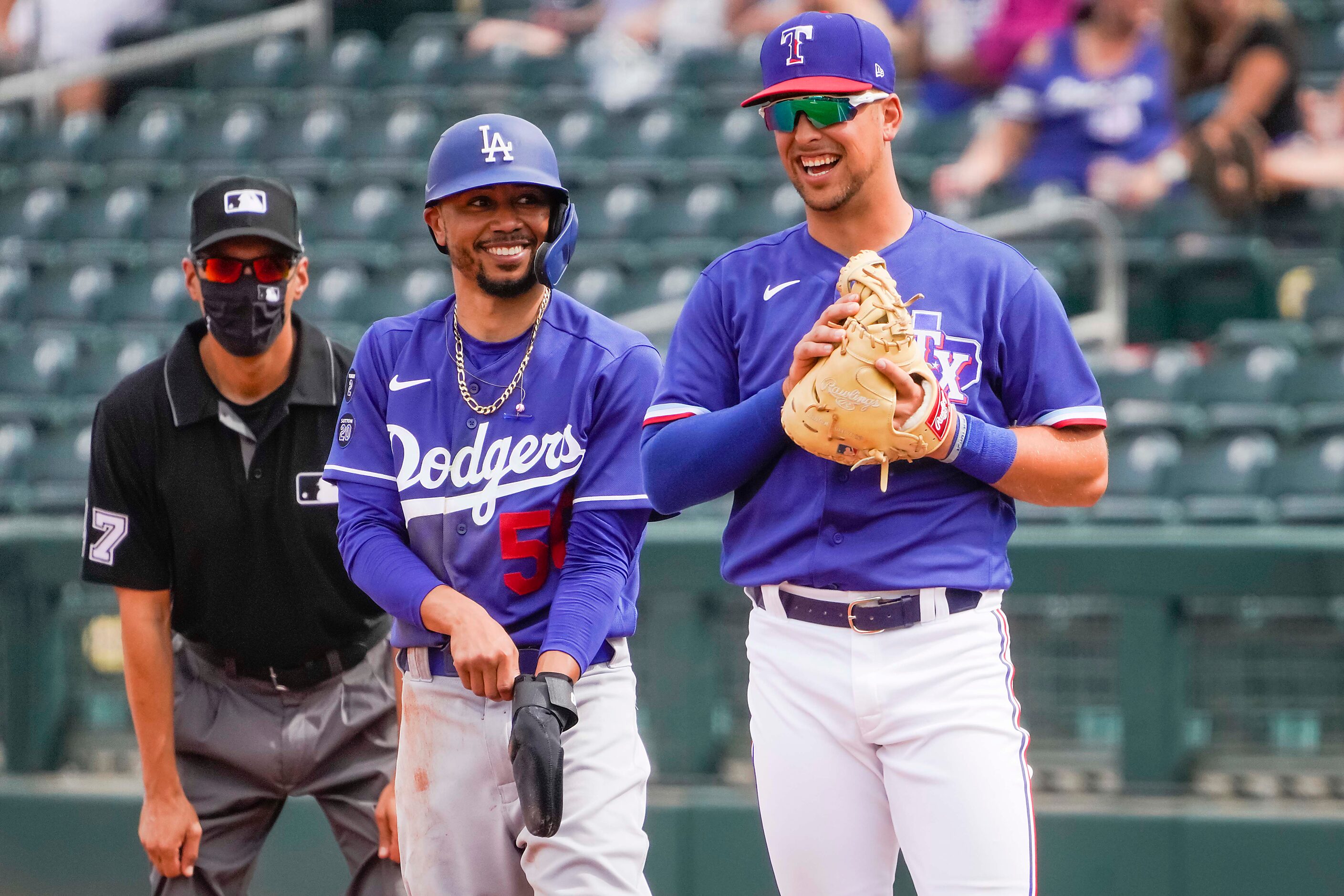 Texas Rangers first baseman Nate Lowe laughs with Los Angeles Dodgers right fielder Mookie...