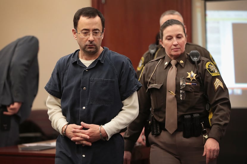 Larry Nassar appears in court to listen to victim impact statements after being accused of...