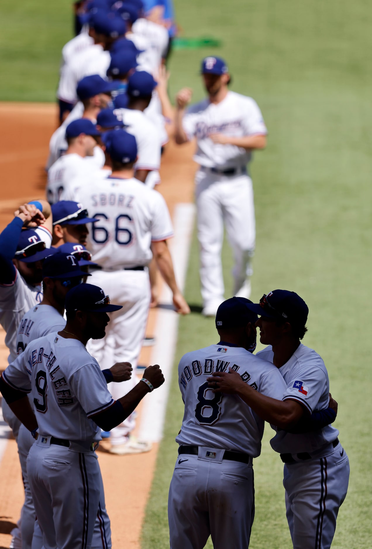 Texas Rangers manager Chris Woodward hugged his players as they're introduced during pregame...