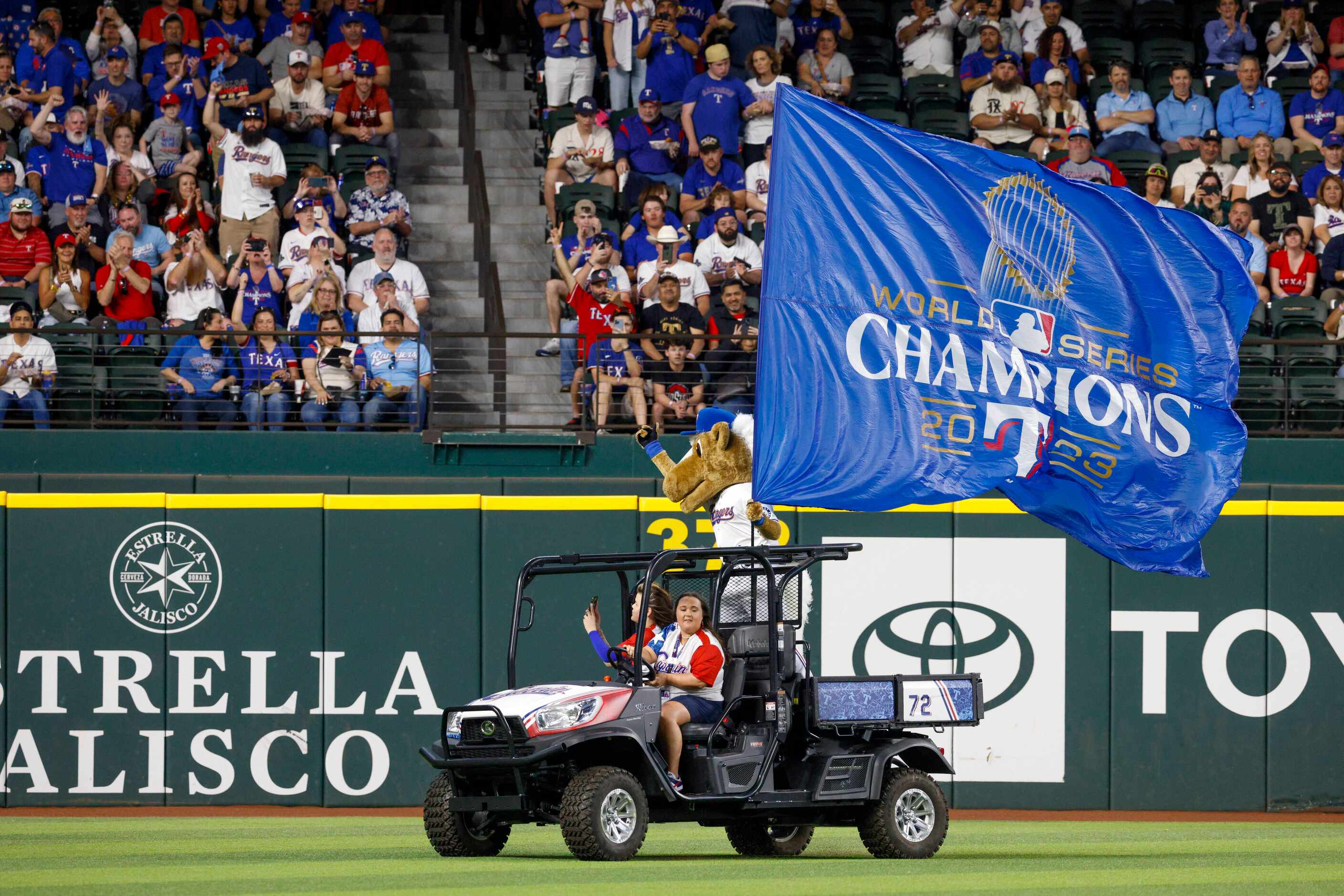 Texas Rangers mascot Captain holds a World Series Champions flag as he rides around the...