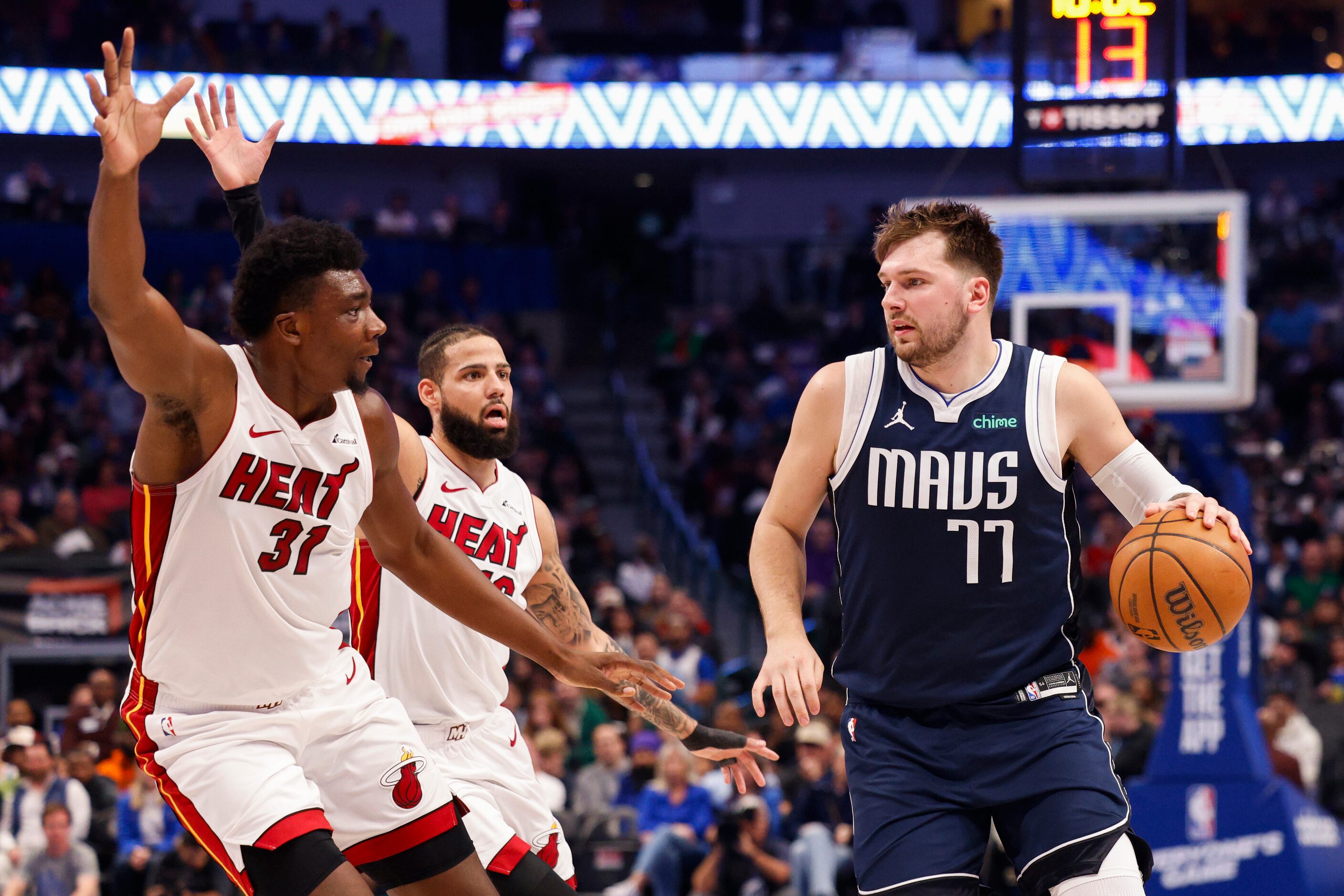 Dallas Mavericks guard Luka Doncic (77) dribbles up court against Miami Heat center Thomas...