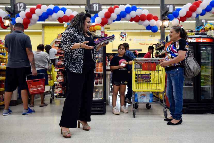 Poet and actress Priscilla Rice, 43, of Dallas reads her poetry to families waiting to pay...