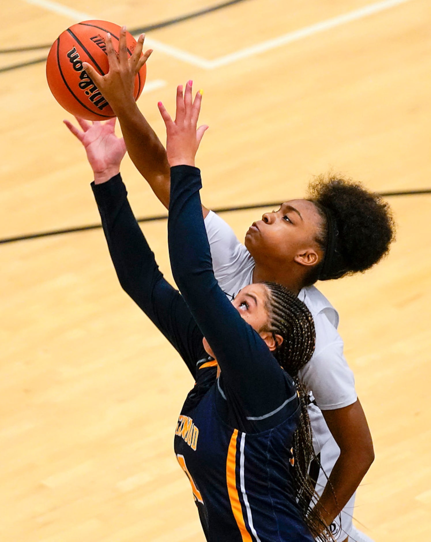 Bishop Lynch guard Maddie Cockrell (top) fights for a rebound against Prestonwood Christian...