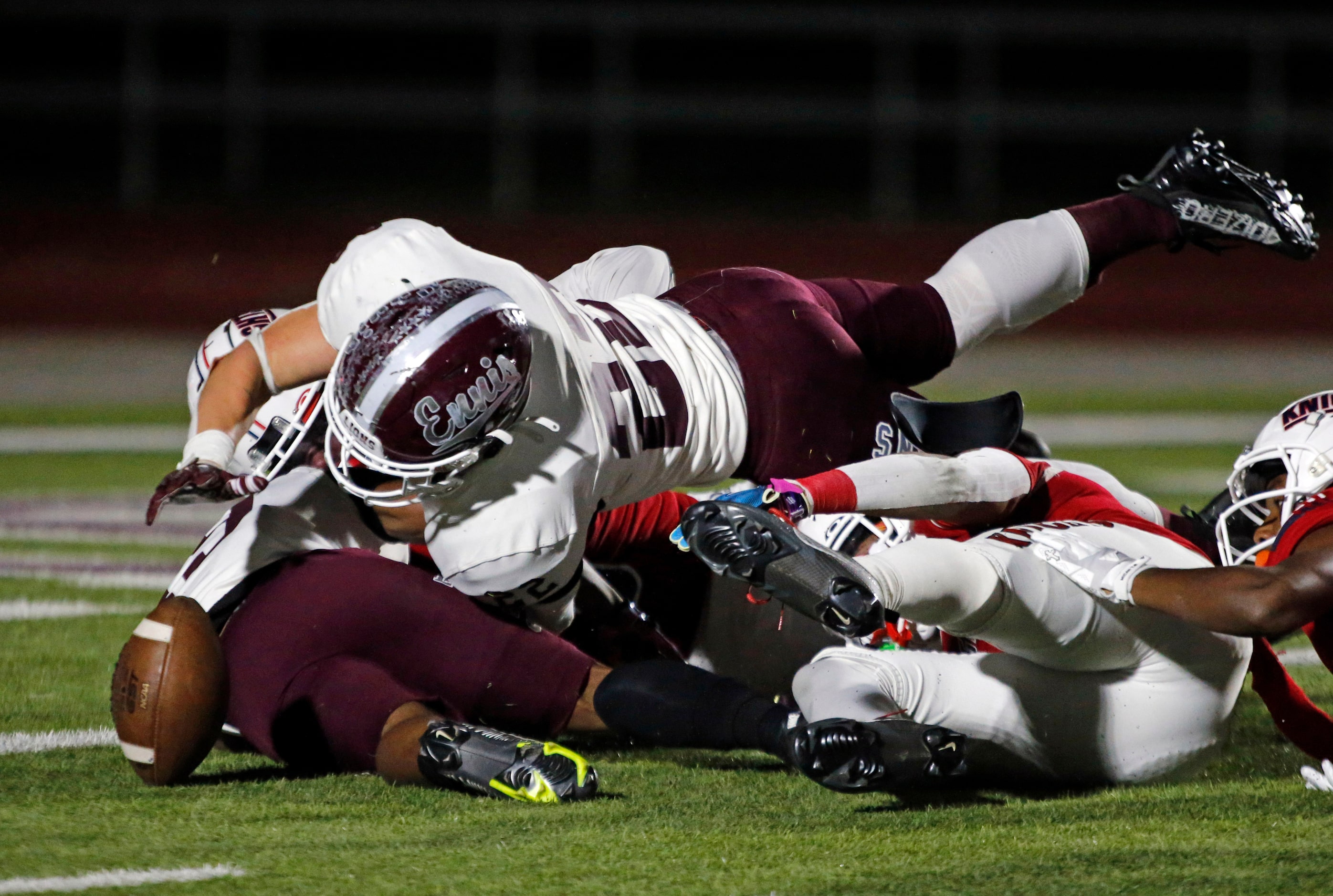 Ennis high’s Malachi Perez (22) goes over the top to recover a teammate’s fumble during the...