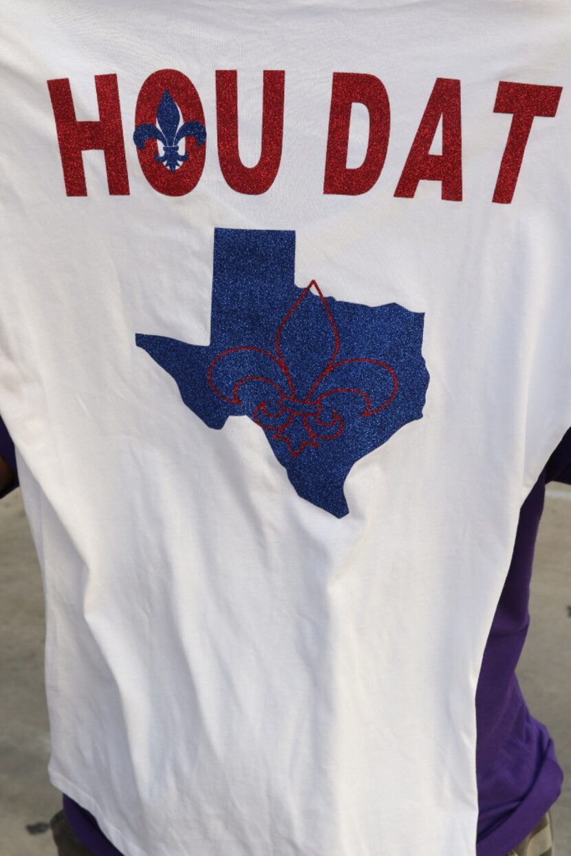 Dionne Cryer, a Hurricane Katrina survivor, shows the back of her T-shirt. She and a group...