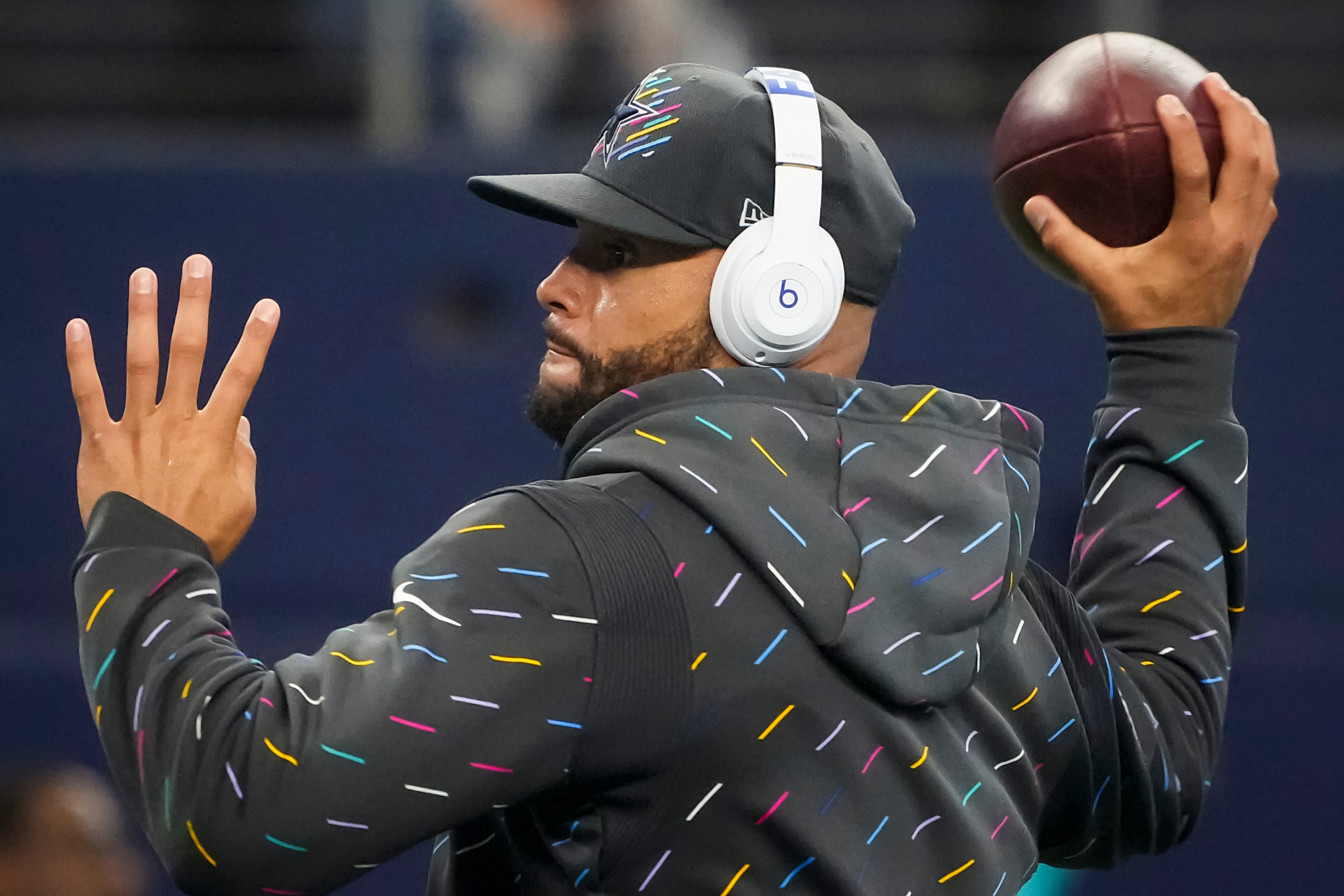 Dallas Cowboys quarterback Dak Prescott warms up before an NFL football game against the...