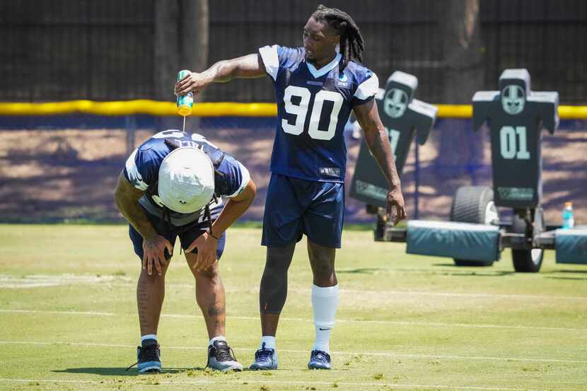 Dallas Cowboys defensive end DeMarcus Lawrence (90) pours water on defensive tackle Trysten...
