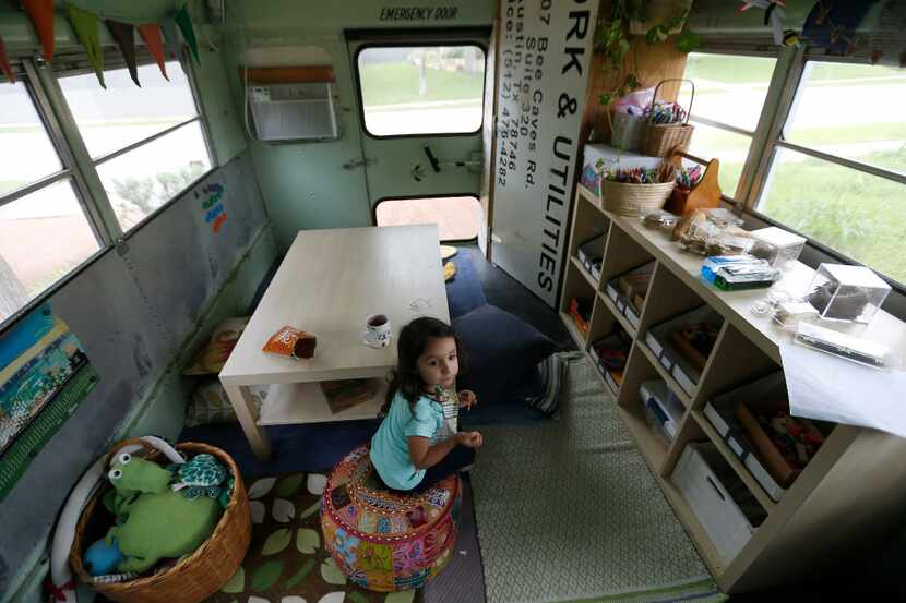 Inez Beltran, 3, eats snacks at Seed Preschool, a mobile school inside a bus, parked at...
