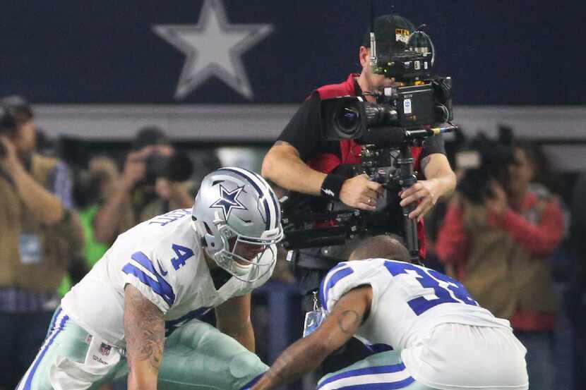 The TV camera records Dallas Cowboys quarterback Dak Prescott (4) and cornerback Orlando...