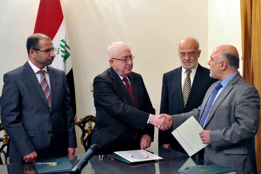 
Newly elected Iraqi parliament speaker Salim al-Juburi (left) watches as Iraqi President...