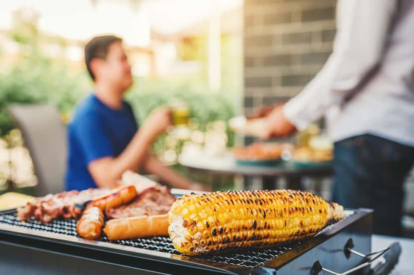 Afternoon Party Group friends enjoying drinking beer with barbecue and roast pork happy...