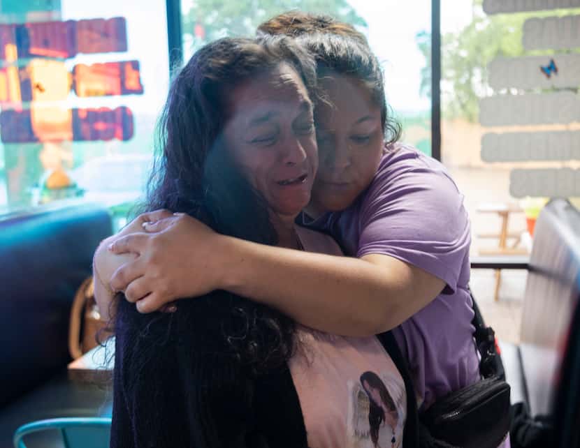 Linda Lopez, left, is held by her daughter, Erica Hernandez, as she cries while talking...
