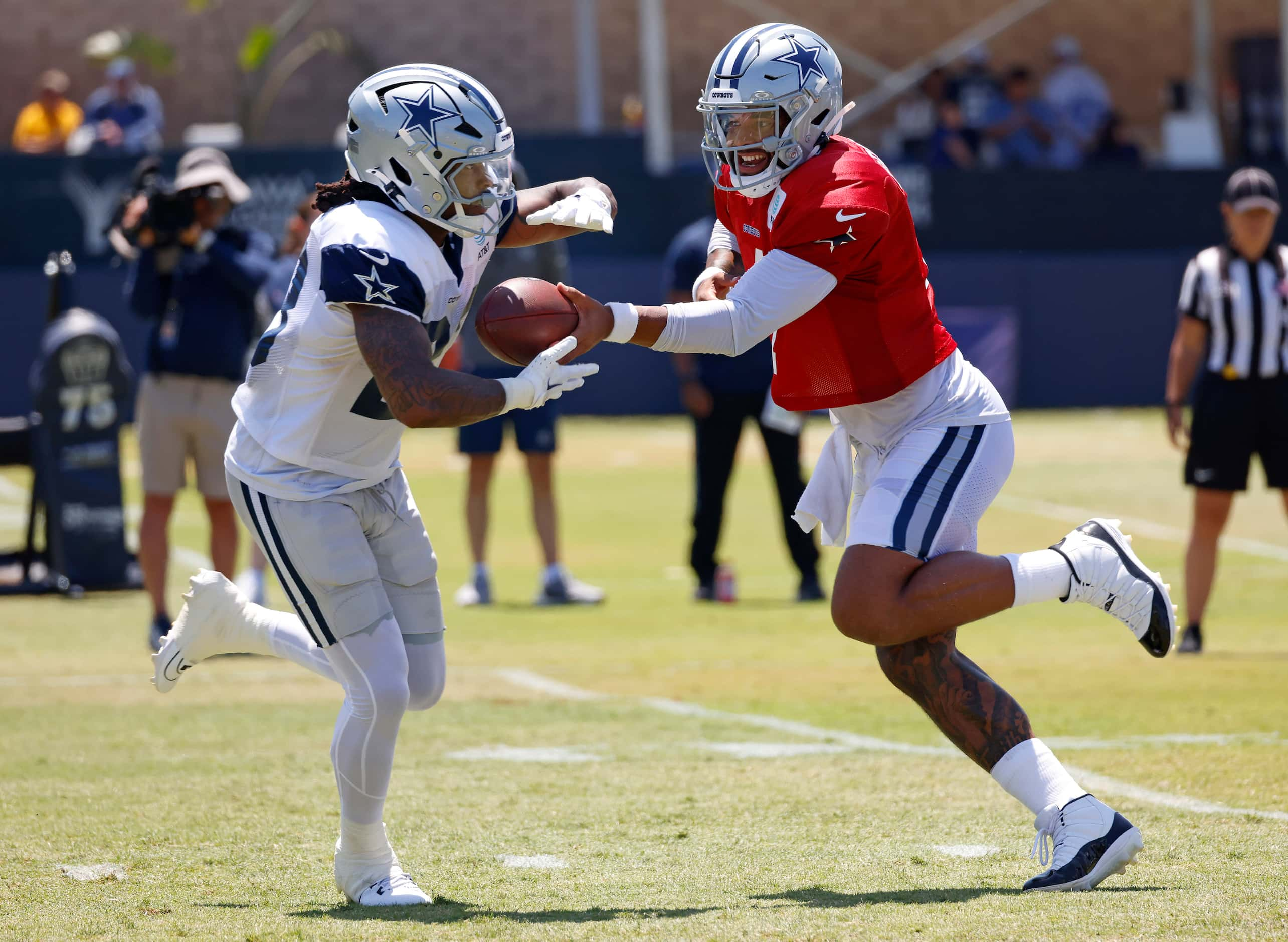 Dallas Cowboys quarterback Dak Prescott (4) hands the football off to running back Rico...