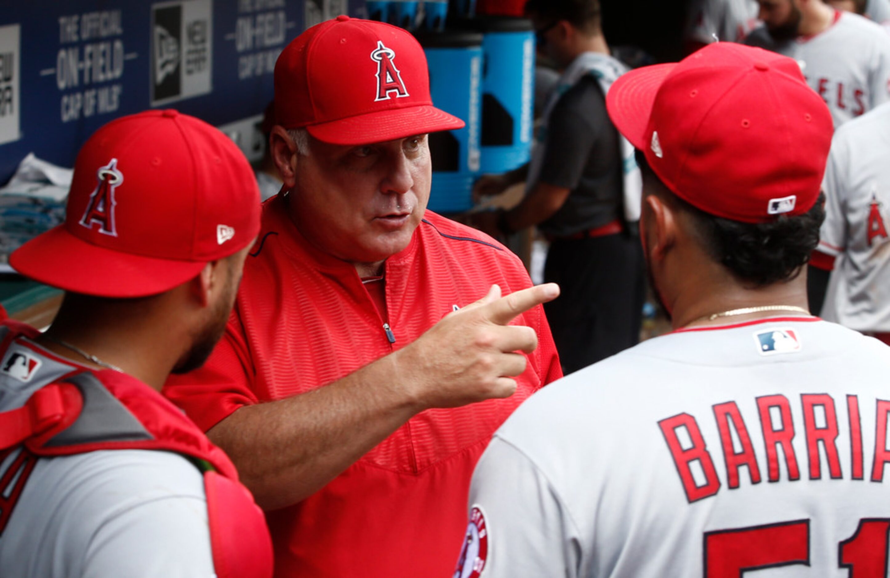 Los Angeles Angels manager Mike Scioscia talks to starting pitcher Jaime Barria as catcher...