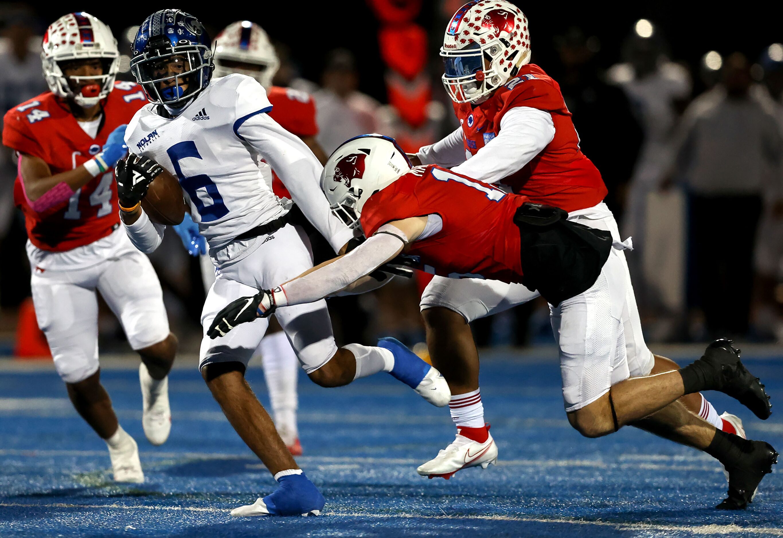 Nolan wide receiver Jaiden Burnett tries to elude Parish defensive back Cooper Mailand (R)...