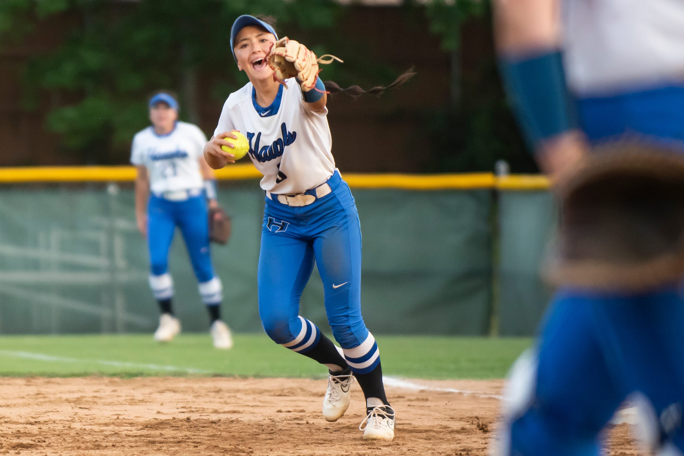 Shorey Nguyen (8) cheers after catcher Zoe Bowen (15) made a play to get the out at first...