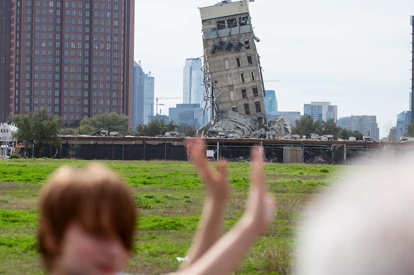 Randy Gibson takes a photo of his son Andrew, 11, in front of the 'Leaning Tower of Dallas'...