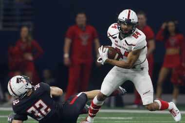 Texas Tech receiver Erik Ezukanma (84) pulls in a pass and is able to elude the defensive...